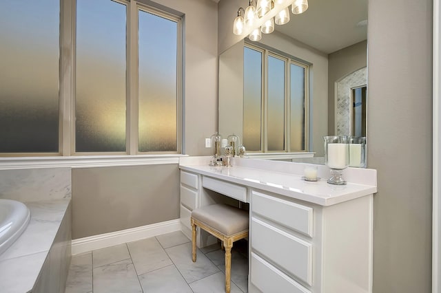 bathroom featuring a relaxing tiled tub and vanity