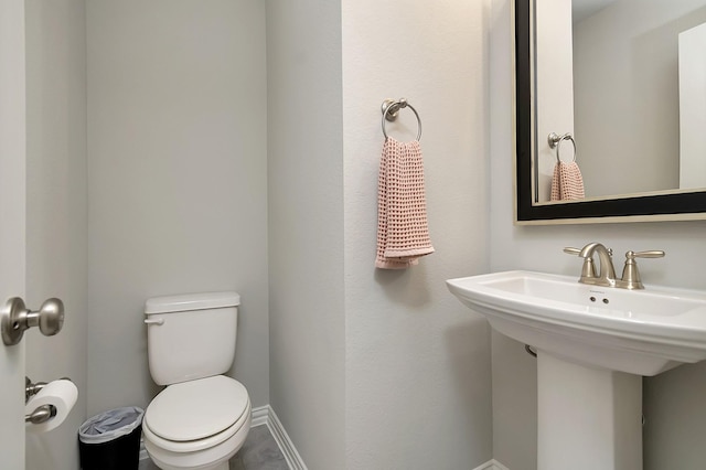 bathroom featuring sink and toilet