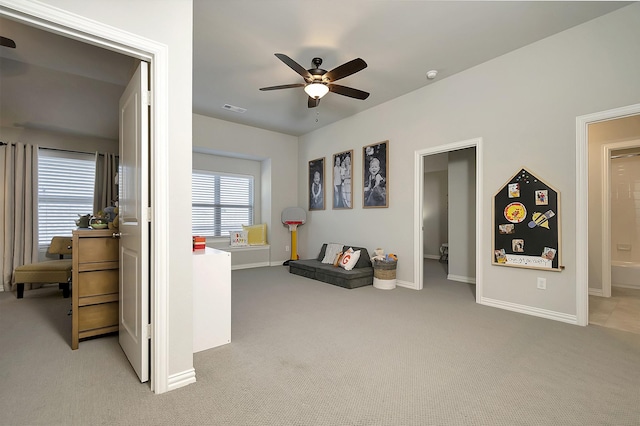 interior space with ceiling fan and light colored carpet