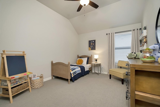 carpeted bedroom with ceiling fan and vaulted ceiling