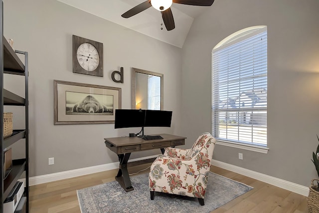 home office with ceiling fan, light wood-type flooring, and vaulted ceiling