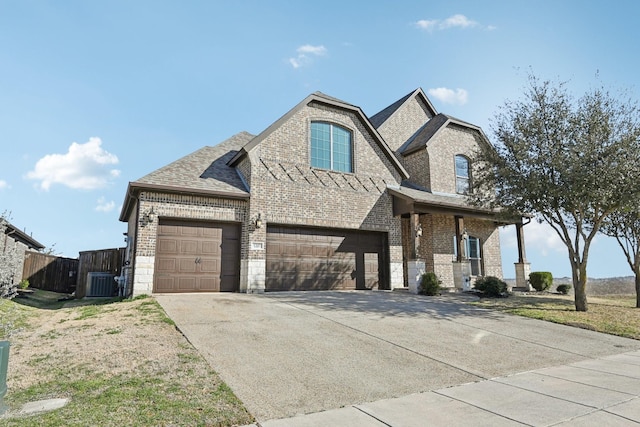 view of front of house with driveway, fence, and brick siding