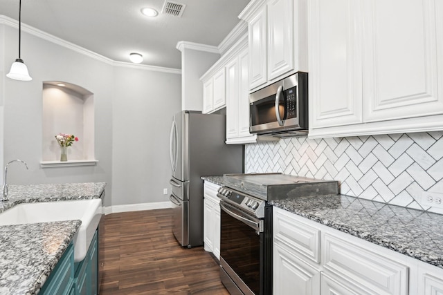 kitchen with stone countertops, visible vents, white cabinets, stainless steel appliances, and pendant lighting