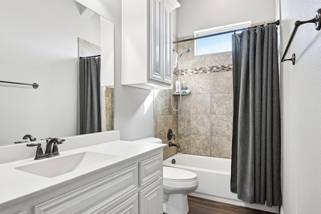 bathroom with toilet, wood finished floors, shower / bath combo with shower curtain, and vanity