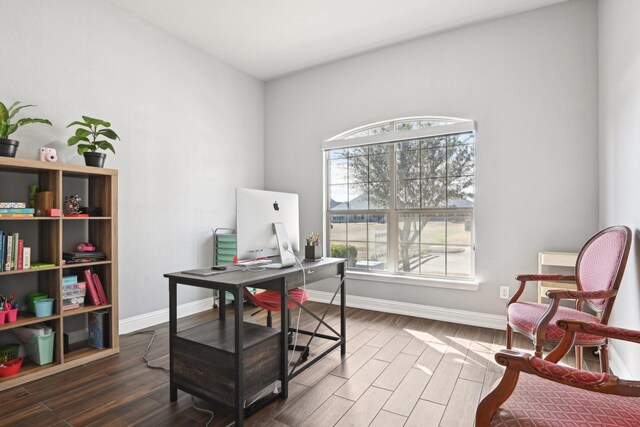 home office with dark wood-style floors and baseboards