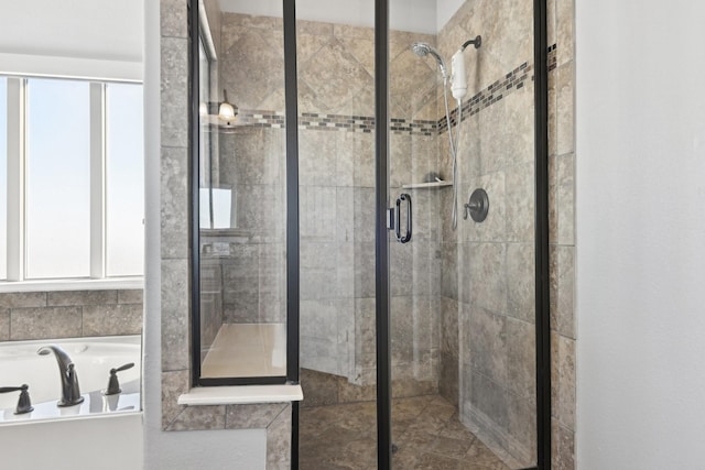 full bathroom featuring a stall shower and a bath
