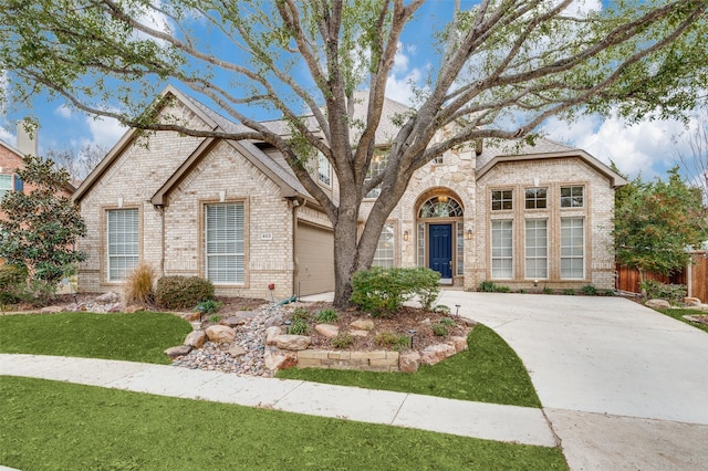 view of front of property with a garage and a front lawn