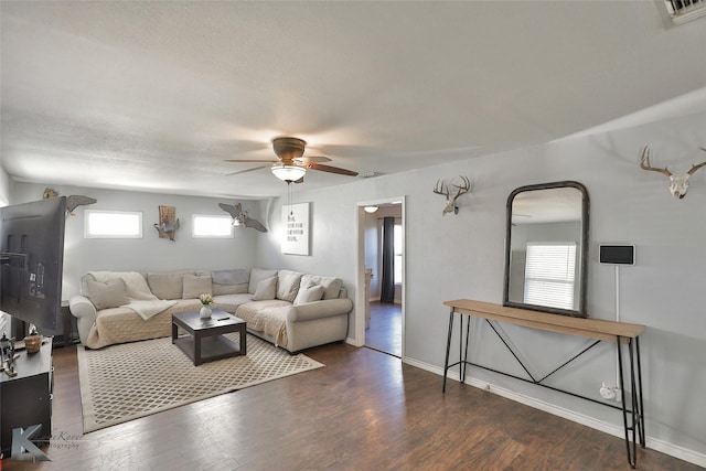 living room with ceiling fan, a healthy amount of sunlight, and dark hardwood / wood-style floors