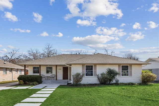 single story home with a porch and a front yard