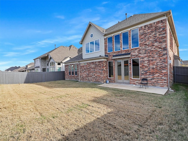 rear view of property with a patio, french doors, and a lawn