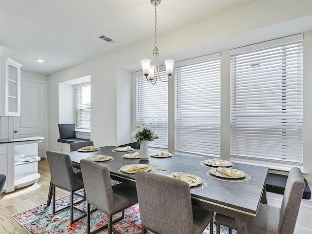 dining area featuring a chandelier and light hardwood / wood-style floors