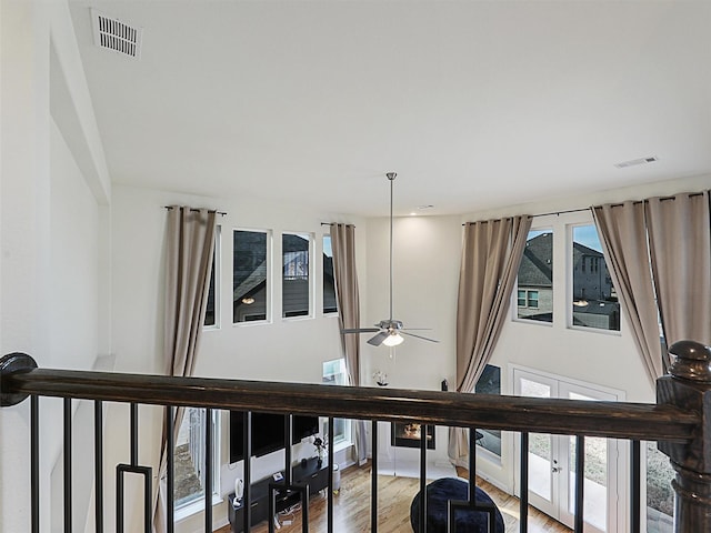 interior space with hardwood / wood-style flooring, ceiling fan, and french doors