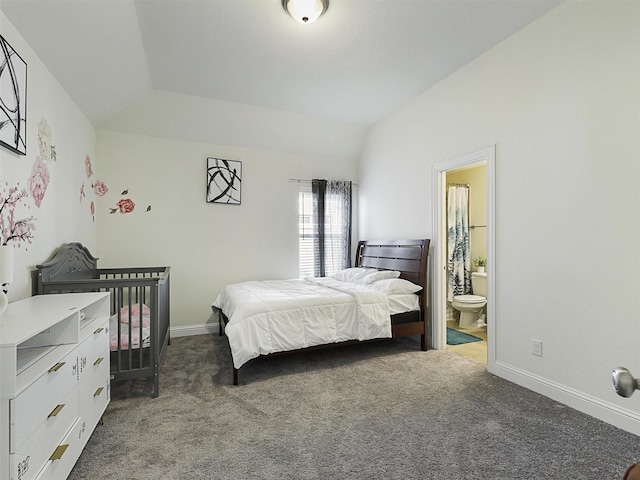 bedroom with vaulted ceiling, ensuite bath, and carpet