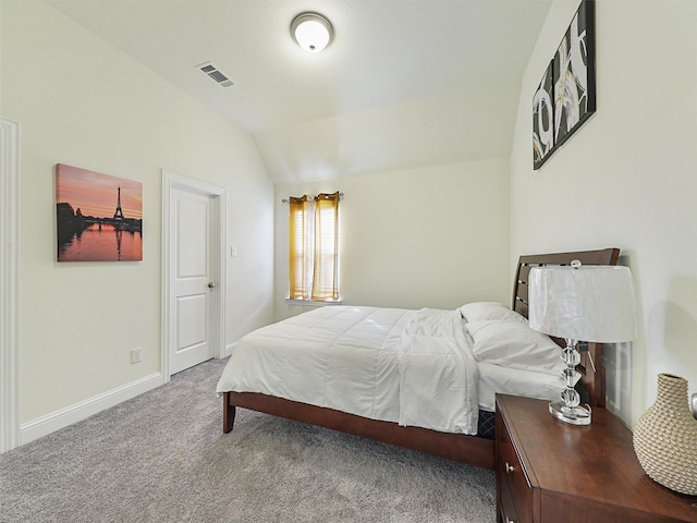 carpeted bedroom with lofted ceiling