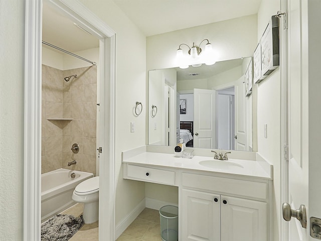 full bathroom featuring toilet, vanity, tile patterned floors, and tiled shower / bath