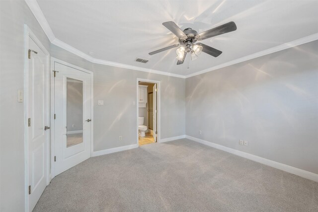 carpeted spare room featuring ceiling fan and ornamental molding