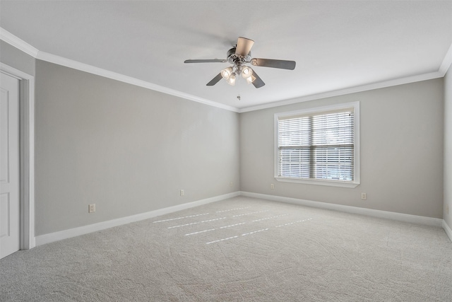 carpeted spare room featuring ceiling fan and crown molding