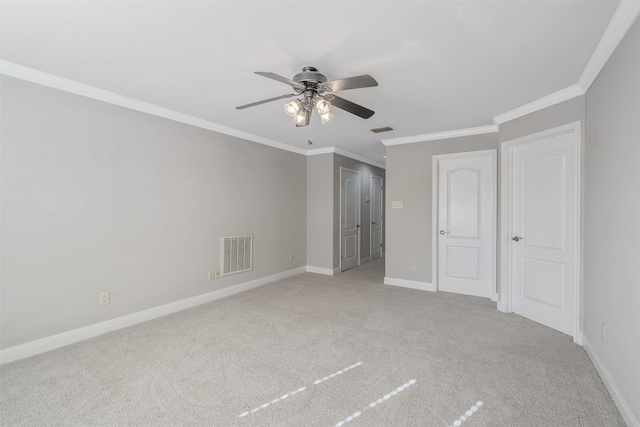 unfurnished bedroom featuring ceiling fan, crown molding, and light carpet