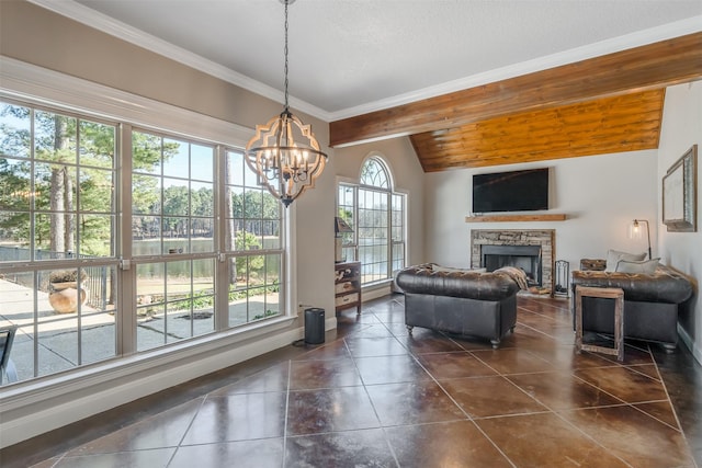 interior space featuring plenty of natural light, lofted ceiling with beams, a stone fireplace, and a chandelier