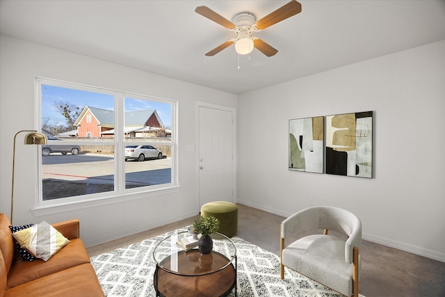 living area with carpet and ceiling fan