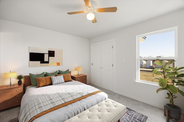 bedroom featuring carpet, ceiling fan, and a closet