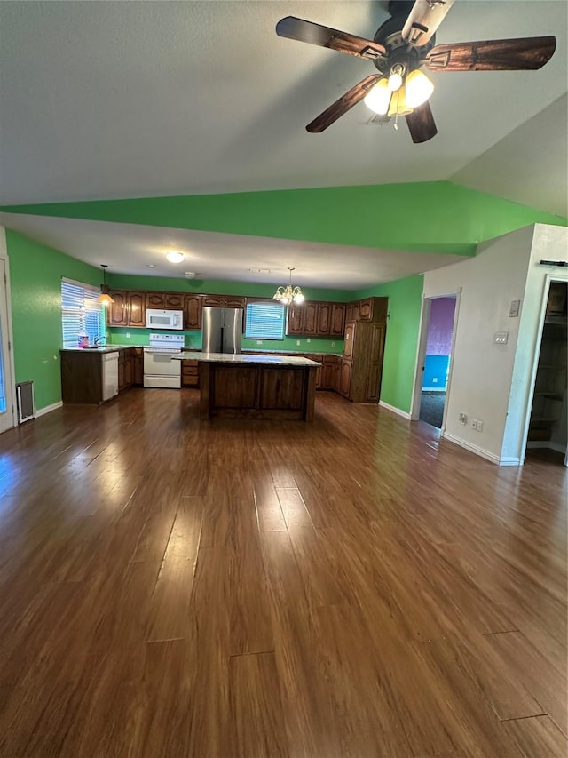 kitchen featuring dark hardwood / wood-style floors, white appliances, decorative light fixtures, and a center island