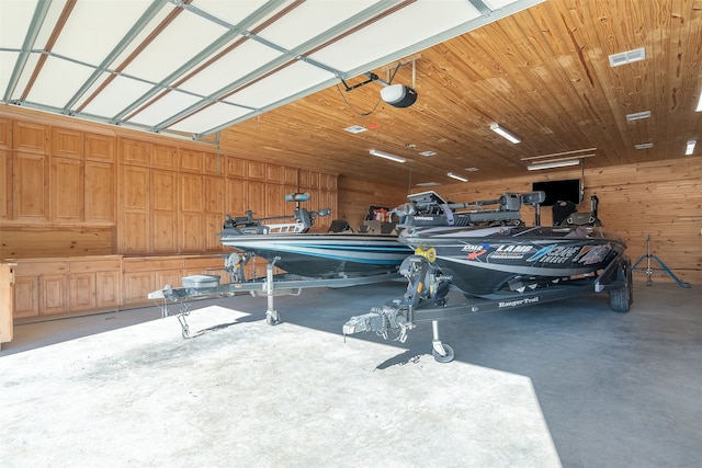 garage featuring wood ceiling, a garage door opener, and wooden walls