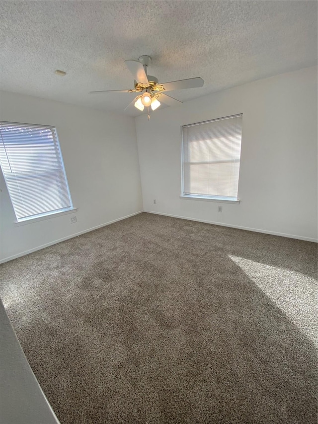 unfurnished room featuring carpet flooring, ceiling fan, and plenty of natural light