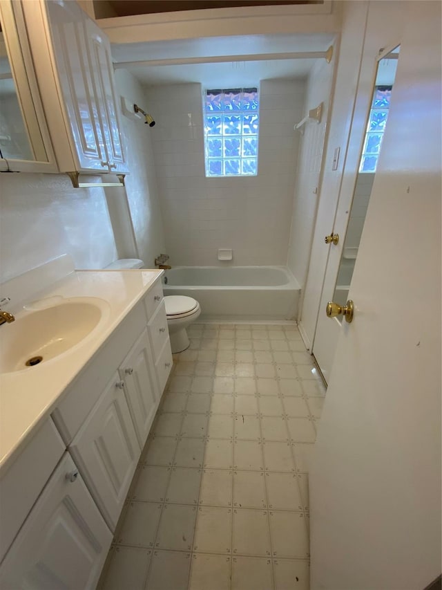 full bathroom featuring toilet, vanity, and tiled shower / bath combo