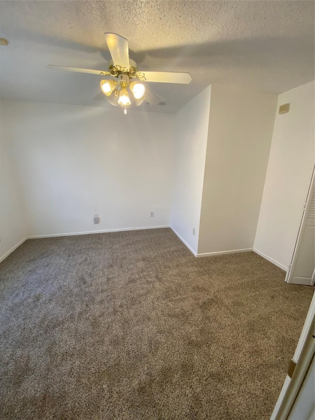 carpeted empty room featuring ceiling fan and a textured ceiling