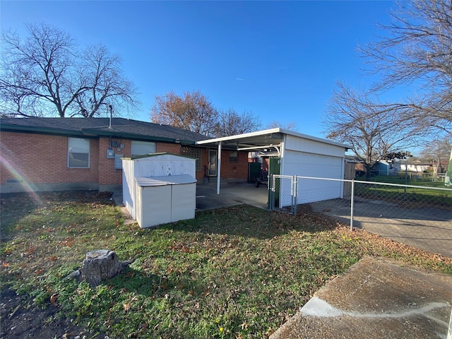 view of side of home with a lawn and a carport