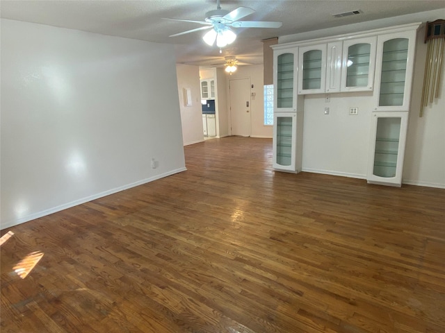 unfurnished living room featuring dark hardwood / wood-style floors and ceiling fan