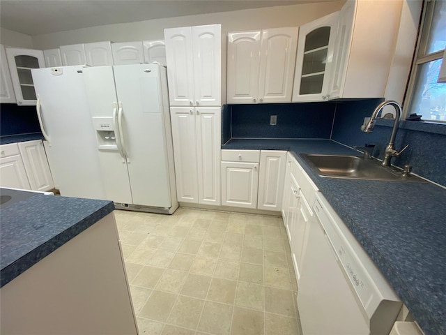 kitchen featuring white cabinets, white appliances, and sink