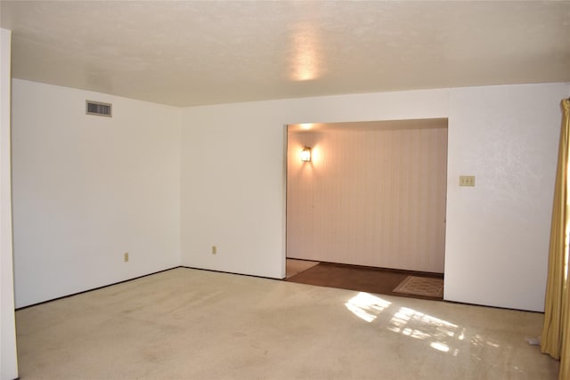 spare room featuring light carpet