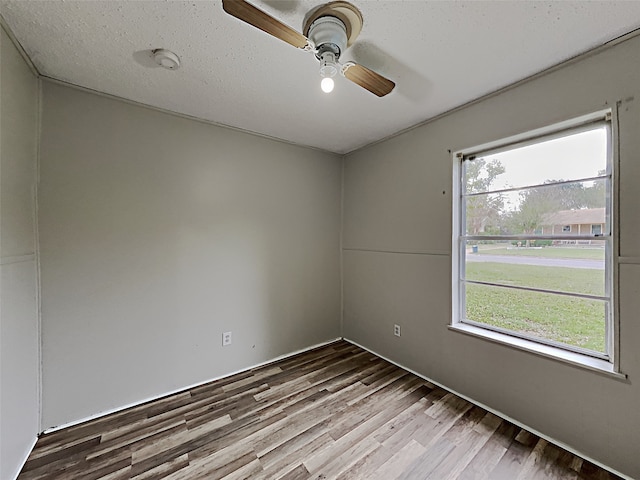 spare room with ceiling fan and wood-type flooring