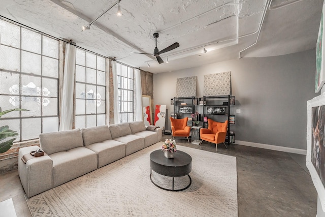 living room featuring ceiling fan and rail lighting