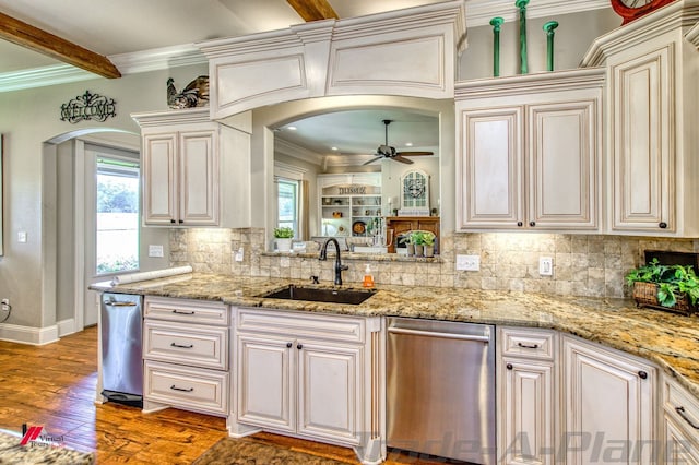 kitchen with hardwood / wood-style floors, sink, ornamental molding, stainless steel dishwasher, and ceiling fan