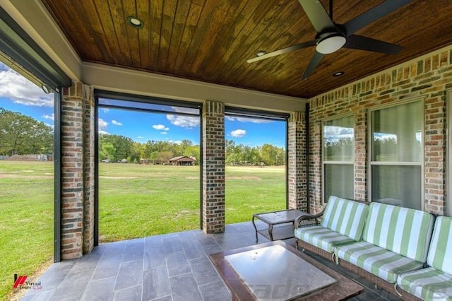 unfurnished sunroom featuring ceiling fan and wood ceiling