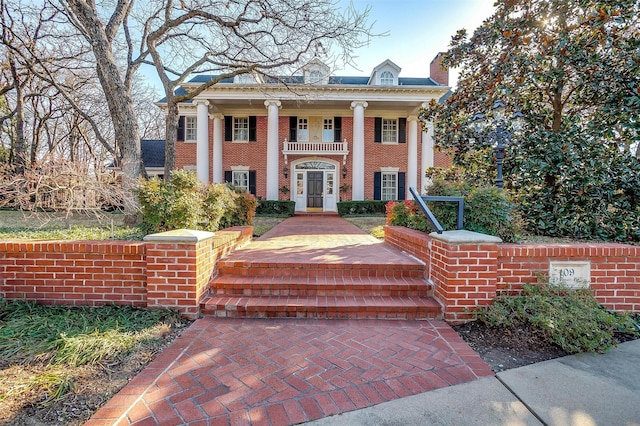 greek revival house featuring a balcony