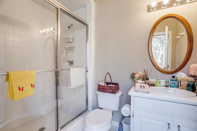 bathroom featuring vanity, toilet, and walk in shower