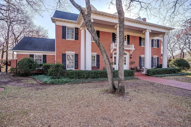 greek revival house with a balcony