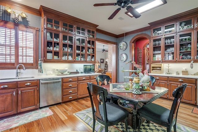 kitchen with dishwasher, sink, light hardwood / wood-style flooring, backsplash, and crown molding