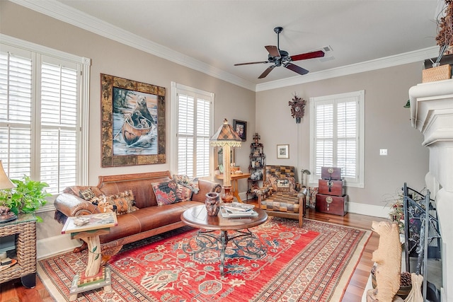 living room with hardwood / wood-style floors, ceiling fan, and crown molding