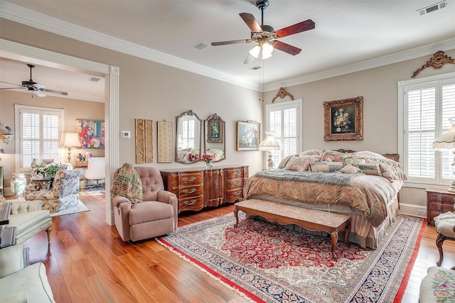 bedroom with hardwood / wood-style floors, ceiling fan, and ornamental molding