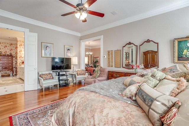 bedroom featuring ensuite bath, crown molding, ceiling fan with notable chandelier, and hardwood / wood-style flooring