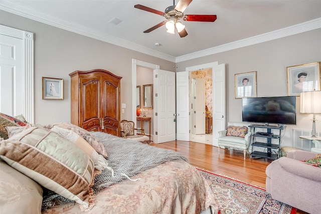 bedroom featuring connected bathroom, ceiling fan, wood-type flooring, and ornamental molding