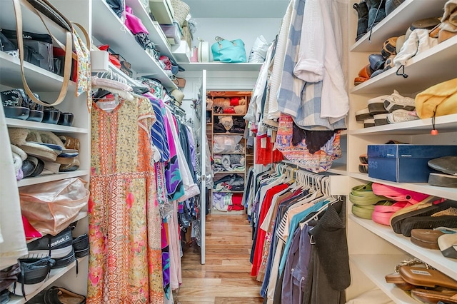 walk in closet featuring light hardwood / wood-style flooring