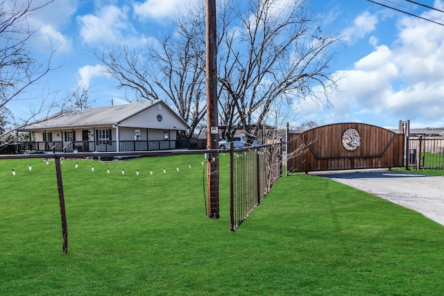 view of yard featuring covered porch