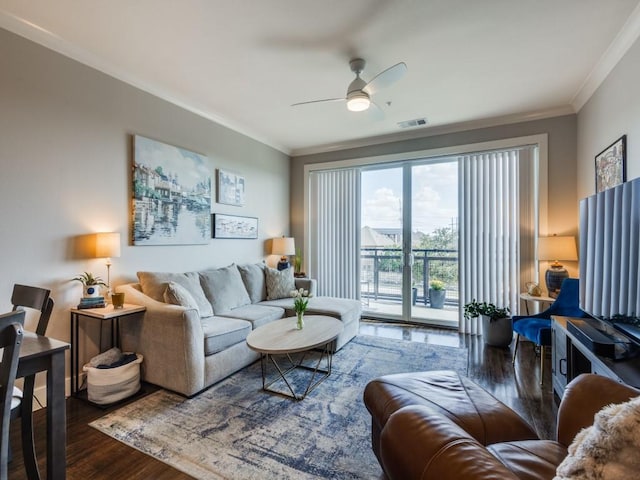 living room featuring ceiling fan, dark hardwood / wood-style flooring, and ornamental molding