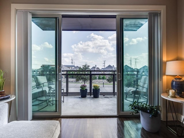 bedroom featuring hardwood / wood-style flooring, access to exterior, and multiple windows